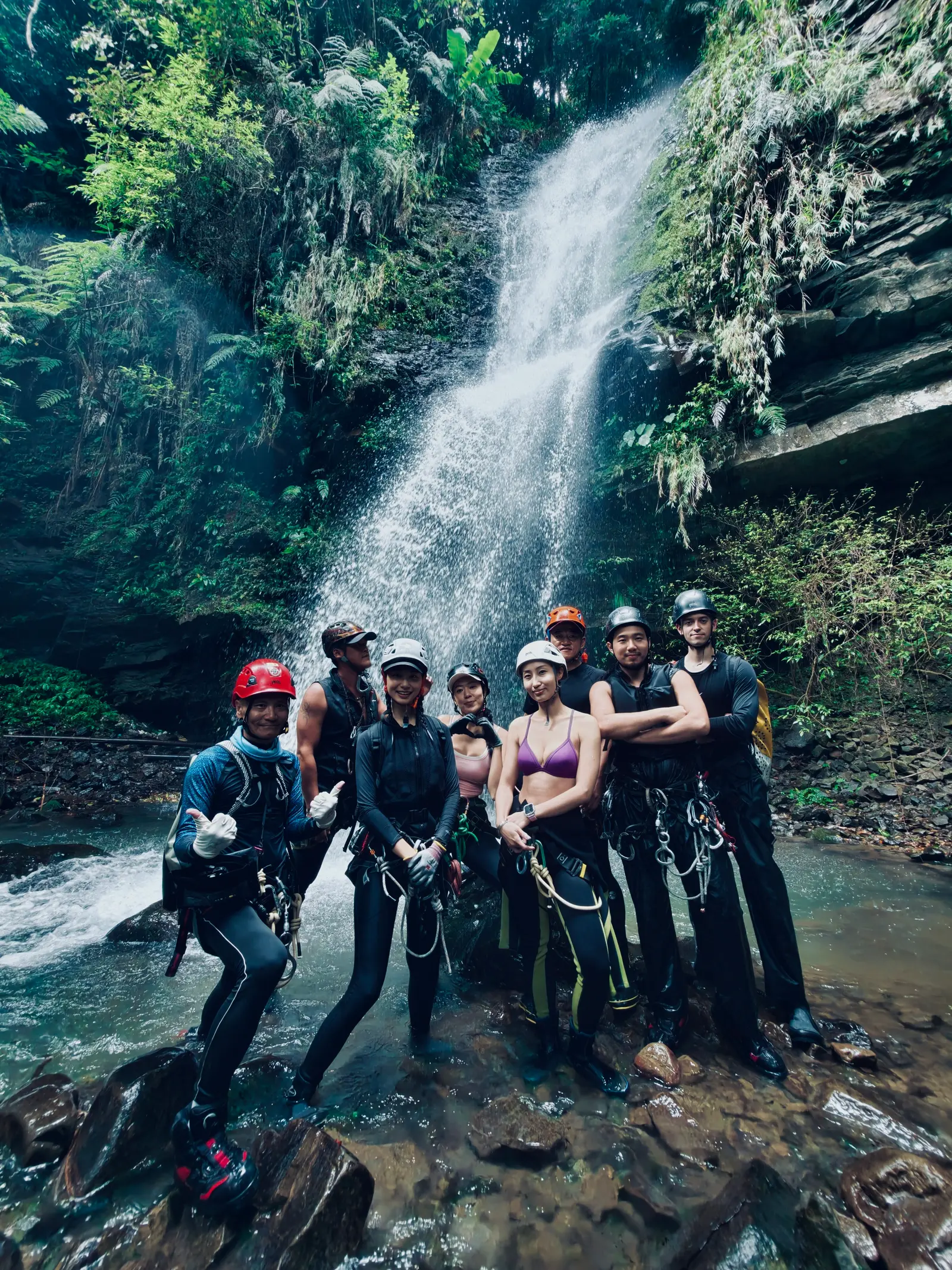 Canyoning guide instructs a client at a rappel station