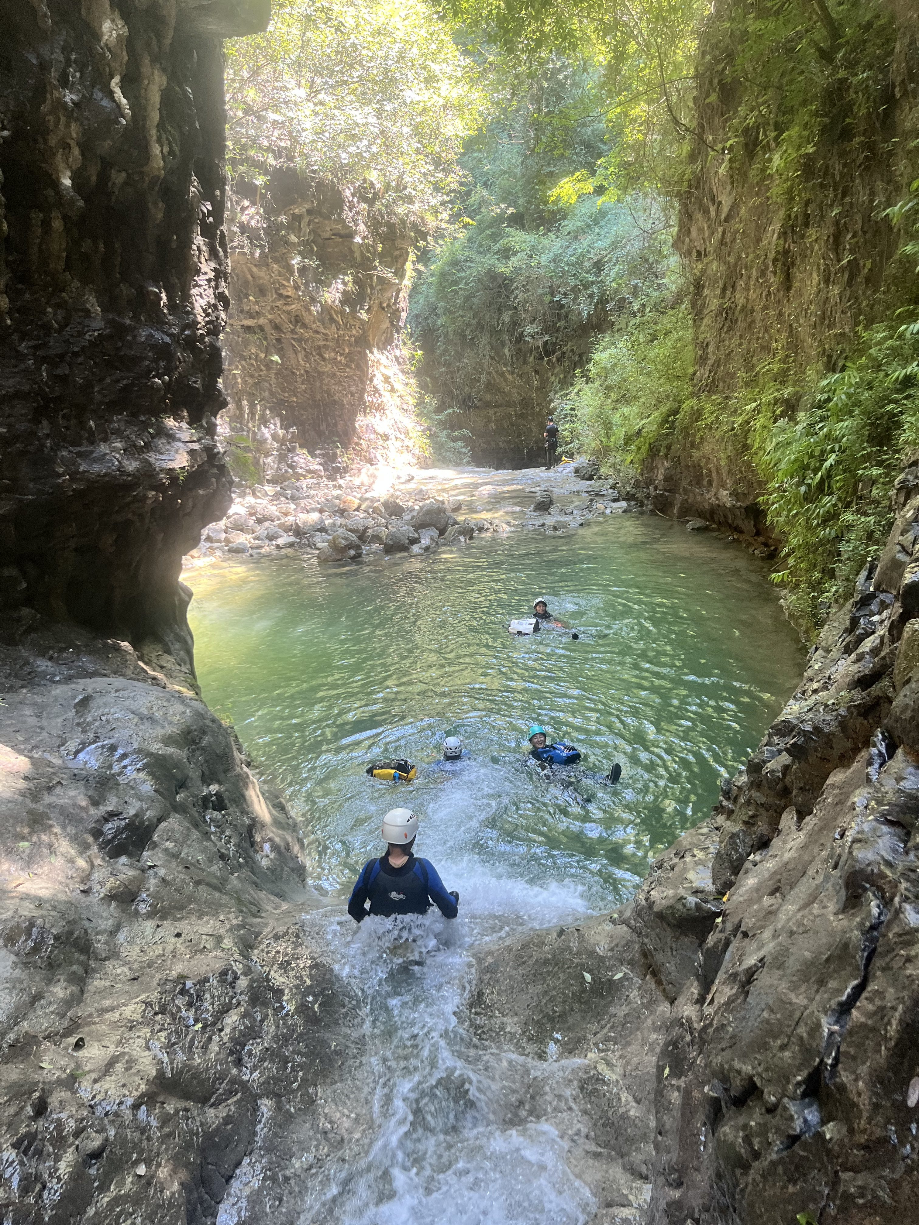 A waterslide opening up into a large circular pool.
