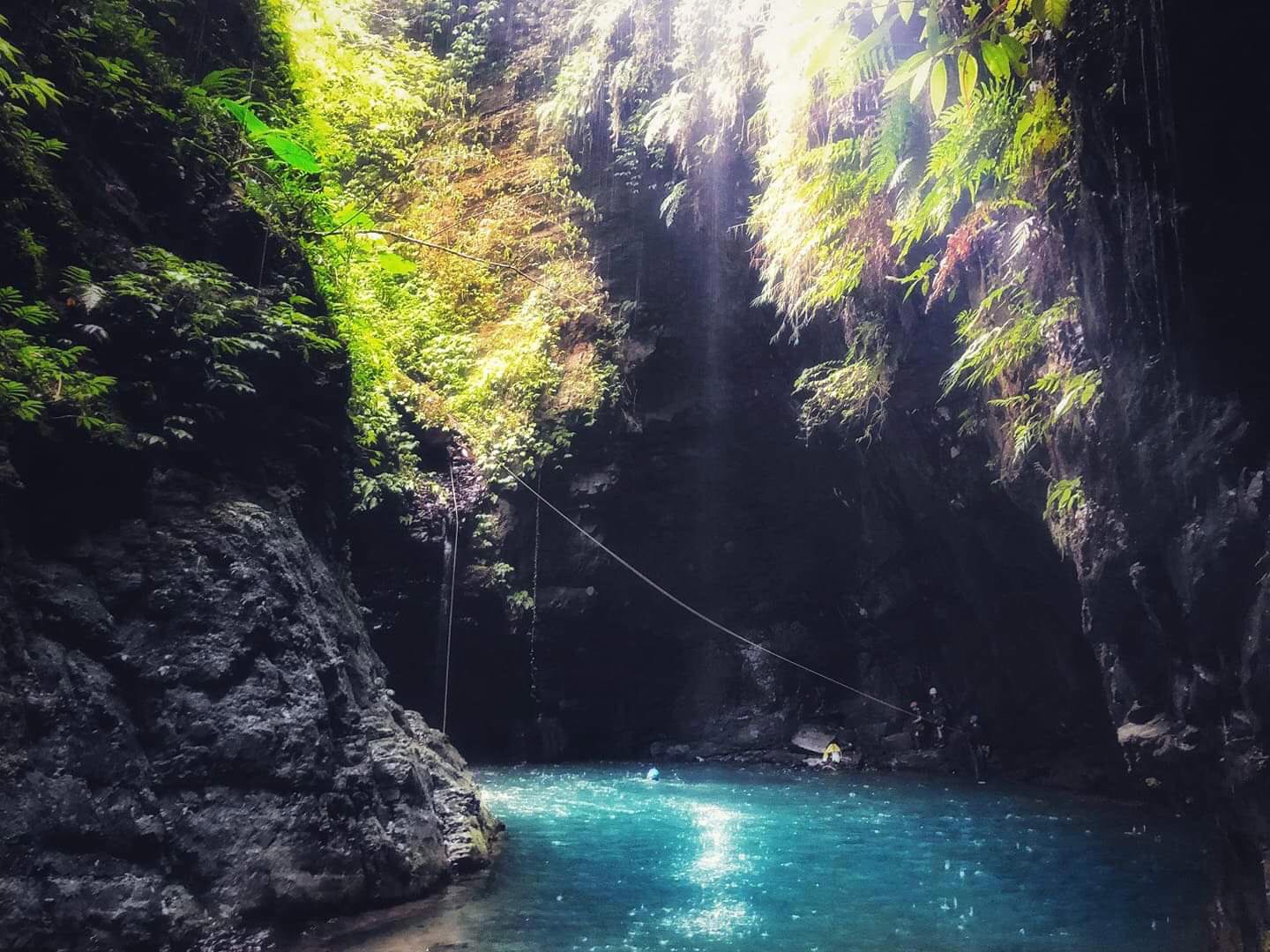 Sunlight shines on a pool of emerald water in Mountain Goat Canyon, Taiwan.