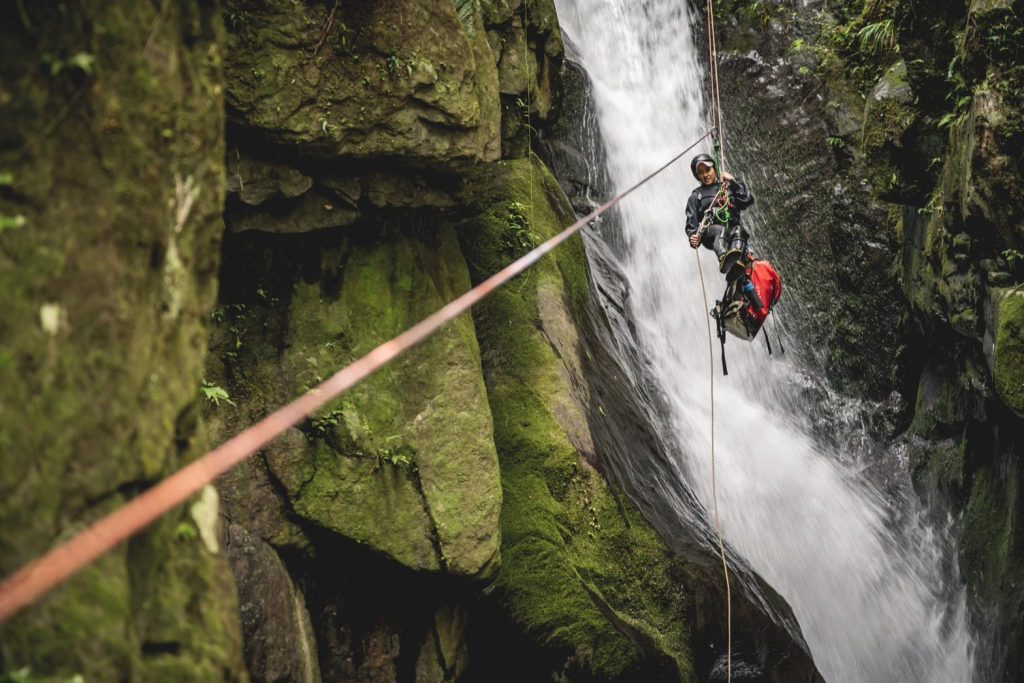 Guided rappel in a canyon.